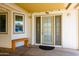 Welcoming entryway featuring a decorative glass door, adjacent windows and a cozy bench at 6177 S Sawgrass Dr, Chandler, AZ 85249