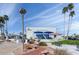 Exterior view of Sunbird Golf Resort with palm trees and manicured landscaping at 6177 S Sawgrass Dr, Chandler, AZ 85249