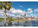 Scenic view of the golf course with lush green grass and mature palm trees by a lake on a sunny day at 6177 S Sawgrass Dr, Chandler, AZ 85249