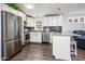 Beautiful kitchen with stainless appliances, granite countertops, and white cabinetry at 6177 S Sawgrass Dr, Chandler, AZ 85249