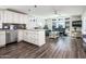 Open-concept living space showcasing the kitchen and living room with hardwood floors at 6177 S Sawgrass Dr, Chandler, AZ 85249