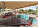 Covered patio view overlooking a pool and golf course beyond, framed by palm trees and blue skies at 6177 S Sawgrass Dr, Chandler, AZ 85249