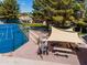 Outdoor tennis court with shade provided by trees, picnic tables with a canvas awning for relaxing at 6177 S Sawgrass Dr, Chandler, AZ 85249