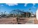 Exterior view of a batting cage with palm trees and desert landscaping at 624 Hawk Eye Dr, Apache Junction, AZ 85119