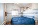 Main bedroom featuring built in storage, wood floors, and large window at 624 Hawk Eye Dr, Apache Junction, AZ 85119