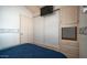 Main bedroom featuring storage, wood floors, and television at 624 Hawk Eye Dr, Apache Junction, AZ 85119