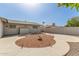 Easy-care backyard with decorative rock landscaping, landscape lighting and block wall surround at 6456 E Dallas St, Mesa, AZ 85205