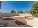 Low maintenance backyard featuring decorative rock, landscape lighting and block wall surround at 6456 E Dallas St, Mesa, AZ 85205