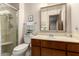 Well-lit bathroom featuring a shower with a glass door and a sink with wood cabinetry at 6456 E Dallas St, Mesa, AZ 85205