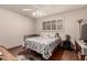 This bedroom features a ceiling fan, window with shutters, and hardwood flooring at 6456 E Dallas St, Mesa, AZ 85205