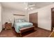 A serene bedroom with hardwood floors, a ceiling fan, and a closet for organized storage at 6456 E Dallas St, Mesa, AZ 85205