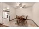 Dining area featuring tile flooring and a wooden table set, bathed in soft, natural light at 6456 E Dallas St, Mesa, AZ 85205