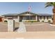 Inviting single-story brick home with a cozy front porch, desert landscaping, and solar panels for energy efficiency at 6456 E Dallas St, Mesa, AZ 85205