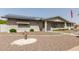 Attractive single-story brick home featuring desert landscaping, a covered porch, and solar panels on the roof at 6456 E Dallas St, Mesa, AZ 85205