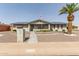 Charming home with desert landscaping, complemented by a mature palm tree and solar panels at 6456 E Dallas St, Mesa, AZ 85205