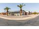 Charming single-story house with desert landscaping, enhanced by palm trees and solar panels at 6456 E Dallas St, Mesa, AZ 85205