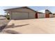 Spacious two-car garage with extended driveway, secured by a painted privacy wall at 6456 E Dallas St, Mesa, AZ 85205