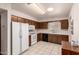 Well-lit kitchen features white appliances, ample cabinet space, and durable tile flooring at 6456 E Dallas St, Mesa, AZ 85205