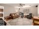 Bright living room with ceiling fan, plantation shutters and comfortable seating area at 6456 E Dallas St, Mesa, AZ 85205