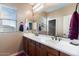 Bright bathroom featuring a dual sink vanity, large mirror and window with lots of natural light at 6795 S Sapphire Way, Chandler, AZ 85249