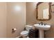 Small bathroom featuring a modern sink and toilet with neutral colored walls and light fixtures at 6795 S Sapphire Way, Chandler, AZ 85249