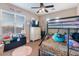 bedroom featuring a bunk bed, dresser, ceiling fan, TV and a comfortable cheetah style rug at 6795 S Sapphire Way, Chandler, AZ 85249