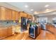 Spacious kitchen with wooden cabinets, stainless steel appliances and wine cooler at 6795 S Sapphire Way, Chandler, AZ 85249