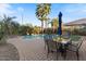 Outdoor patio with a table and chairs set, lush landscaping and a swimming pool views at 6795 S Sapphire Way, Chandler, AZ 85249