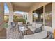 Inviting covered patio featuring brick flooring and comfortable wicker furniture, perfect for relaxing outdoors at 6795 S Sapphire Way, Chandler, AZ 85249