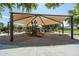 Community playground featuring covered play structure, swings, and slide surrounded by a soft sand surface at 6795 S Sapphire Way, Chandler, AZ 85249