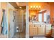 Bright bathroom with a tiled shower, vanity, and ample natural light from the glass block window at 7138 W Buckskin Trl, Peoria, AZ 85383