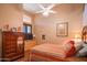 Cozy bedroom with warm colors, natural light, and hardwood floors at 7138 W Buckskin Trl, Peoria, AZ 85383