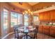 An eat-in kitchen dining area featuring a modern light fixture and a view of the backyard pool at 7138 W Buckskin Trl, Peoria, AZ 85383