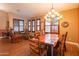 Cozy dining area with a rustic wood table, natural light, and stylish window shutters at 7138 W Buckskin Trl, Peoria, AZ 85383