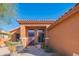 Welcoming home entrance with a stylish door, desert plants, and an inviting outdoor seating area at 7138 W Buckskin Trl, Peoria, AZ 85383