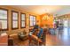 Stylish living room with plantation shutters, hardwood floors, and sophisticated dining area at 7138 W Buckskin Trl, Peoria, AZ 85383