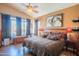 Inviting main bedroom with natural light, warm tones, and a decorative ceiling fan at 7138 W Buckskin Trl, Peoria, AZ 85383