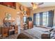 Bright main bedroom featuring hardwood floors, a ceiling fan, and unique decorative touches at 7138 W Buckskin Trl, Peoria, AZ 85383