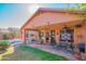 Spacious covered patio with an outdoor dining area overlooking a beautiful pool and landscaped yard at 7138 W Buckskin Trl, Peoria, AZ 85383