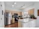 Well-lit kitchen with stainless steel appliances, wood cabinets, and a breakfast bar for modern living at 7401 W Arrowhead Clubhouse Dr # 2079, Glendale, AZ 85308