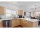 Bright kitchen featuring stainless steel appliances, a large sink, and a breakfast bar overlooking the dining area at 7401 W Arrowhead Clubhouse Dr # 2079, Glendale, AZ 85308