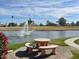 Outdoor seating with pond view and a fountain surrounded by lush greenery at 7401 W Arrowhead Clubhouse Dr # 2079, Glendale, AZ 85308