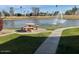 Beautiful pond with fountain, trees and green space, and a picnic table at 7401 W Arrowhead Clubhouse Dr # 2079, Glendale, AZ 85308