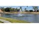 Tranquil view of the pond featuring a fountain and palm trees at 7401 W Arrowhead Clubhouse Dr # 2079, Glendale, AZ 85308