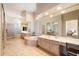 Luxurious primary bathroom with a soaking tub, dual vanities, and glass block accents at 7848 E Parkview Ln, Scottsdale, AZ 85255