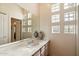 Bathroom features single sink vanity, large mirror, and glass block window at 7848 E Parkview Ln, Scottsdale, AZ 85255