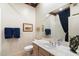 Bright bathroom with sink, toilet and shower-tub combo and blue towels at 7848 E Parkview Ln, Scottsdale, AZ 85255