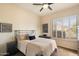 Cozy bedroom with black metal bed, white walls, and ceiling fan at 7848 E Parkview Ln, Scottsdale, AZ 85255