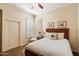 Bedroom with bed and closet, shuttered window, ceiling fan, and light walls at 7848 E Parkview Ln, Scottsdale, AZ 85255