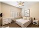 Bright bedroom with double bed, shuttered window, ceiling fan and neutral decor at 7848 E Parkview Ln, Scottsdale, AZ 85255